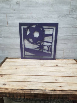 Metal Soccer picture of person kicking ball