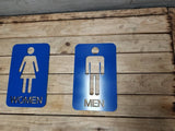 Men and woman metal bathroom door sign